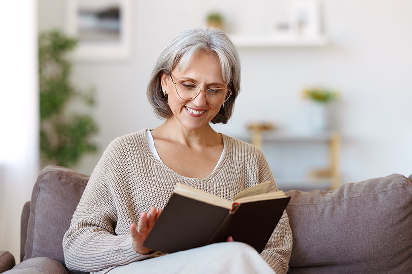 beautiful happy senior woman grey hair eyeglasses reading book