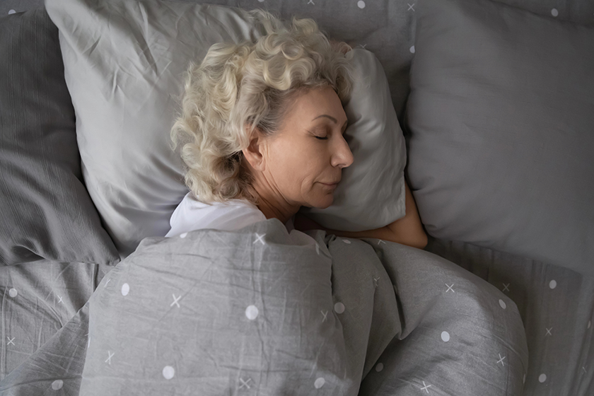calm senior woman sleeping in comfortable