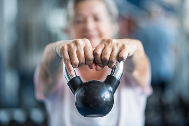 close senior holding weight his hands