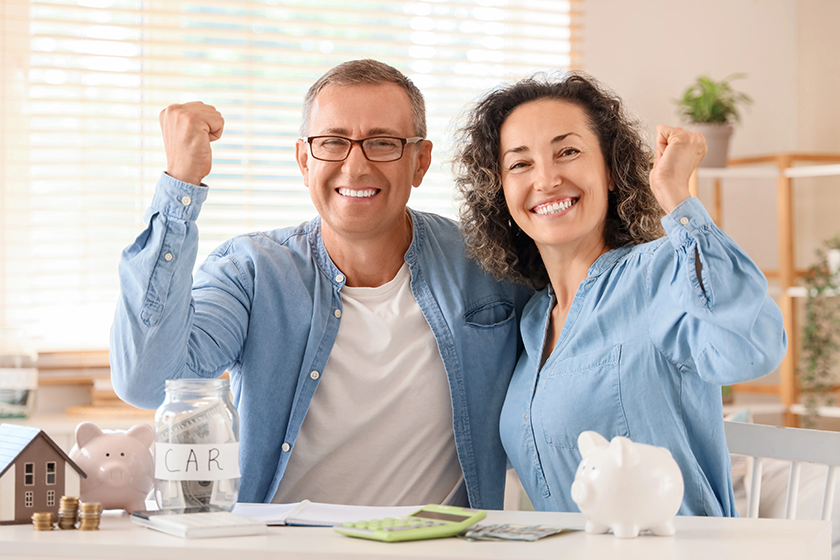 happy couple piggy banks money jar showing yes gesture