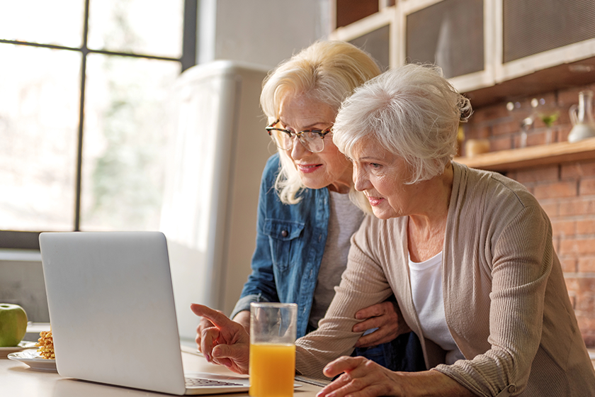 happy old ladies reading recipe from internet