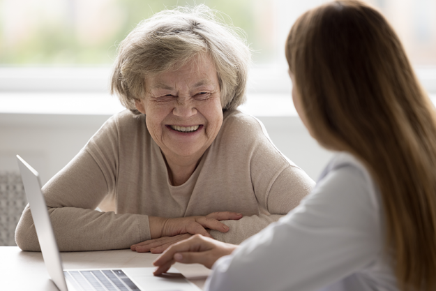 happy positive older patient visiting geriatrician