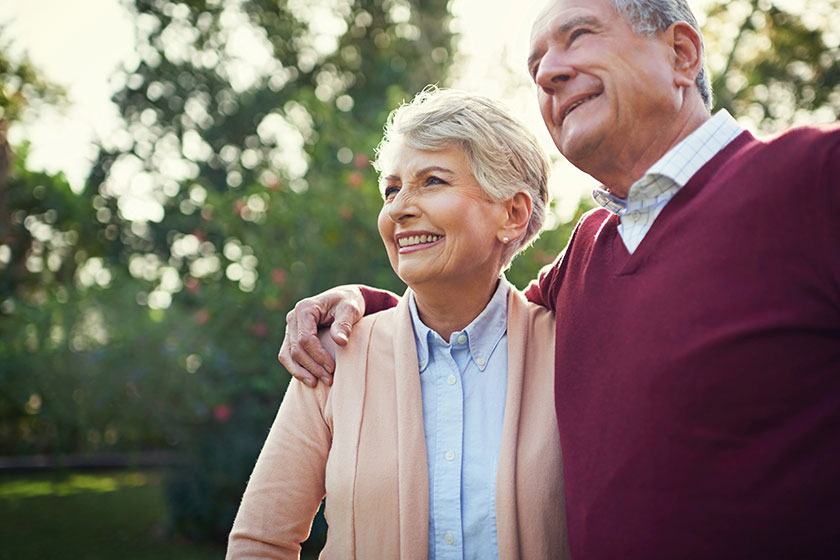 Happy senior couple hug outdoor nature bonding commitment wellness mature