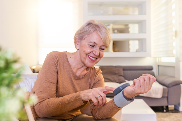 mature woman checking blood pressure mature woman checking blood pressure