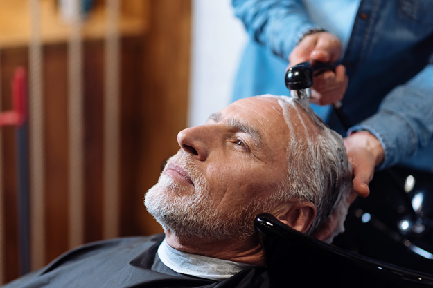 old man during washing his hair in barber shop