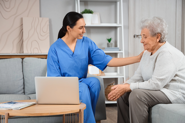 physical therapist using laptop senior woman