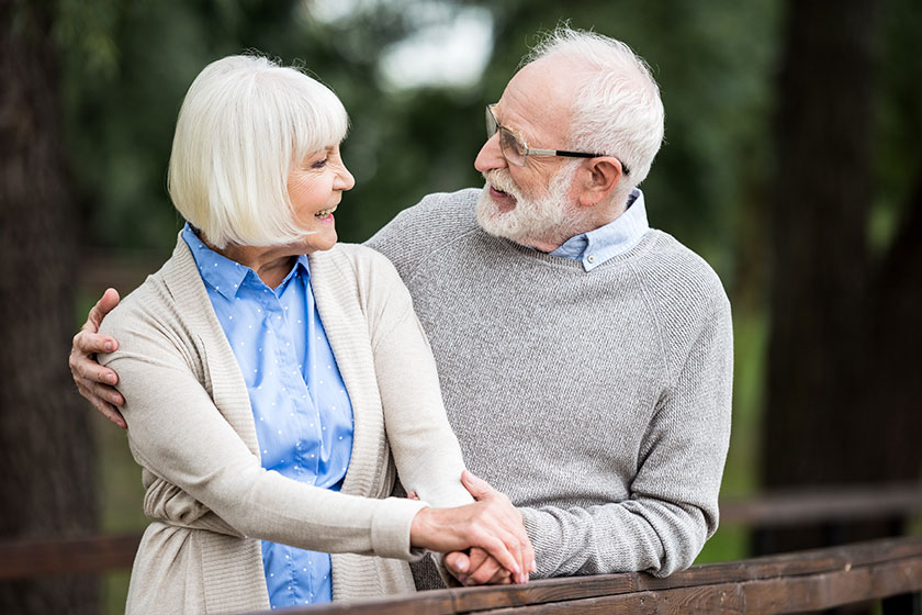 Selective focus happy senior couple holding hands looking each other