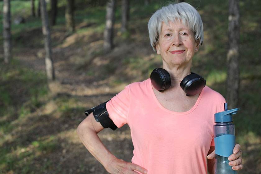 Senior active woman holding water bottle