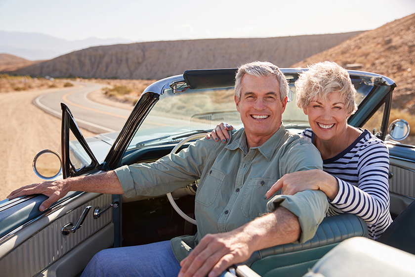 senior couple smiling camera open top car senior couple smiling camera open top car