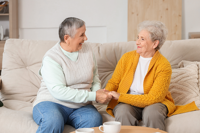 senior female friends holding hands senior female friends holding hands