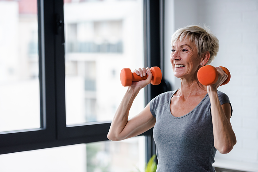 senior woman exercising dumbbells