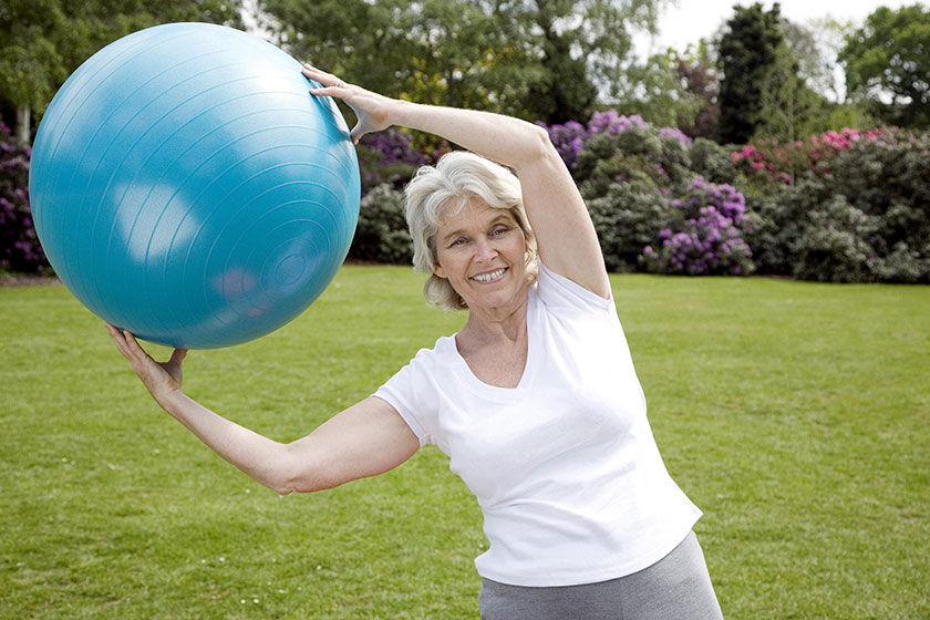 Senior woman holding fitness ball