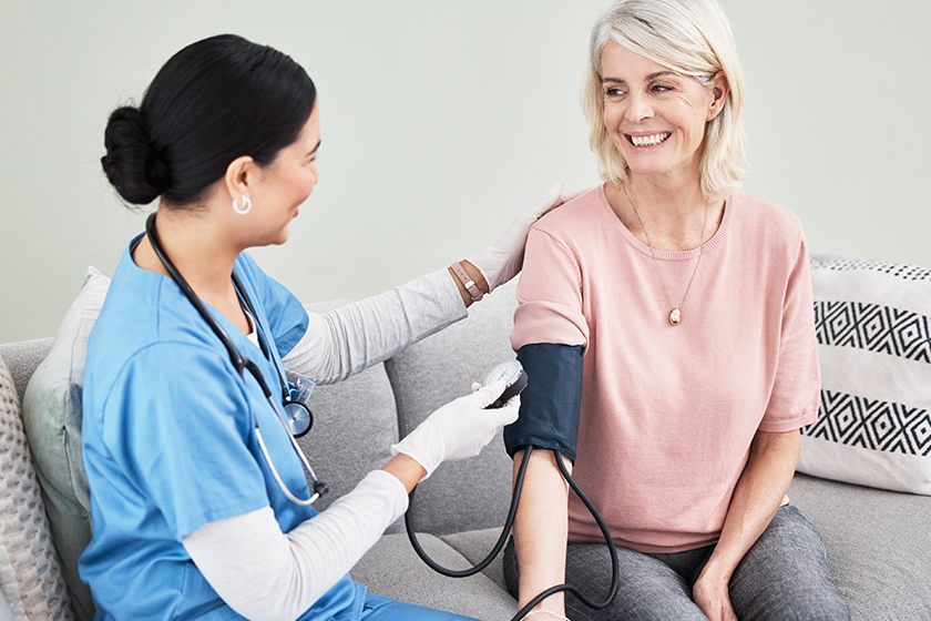 senior woman nurse blood pressure