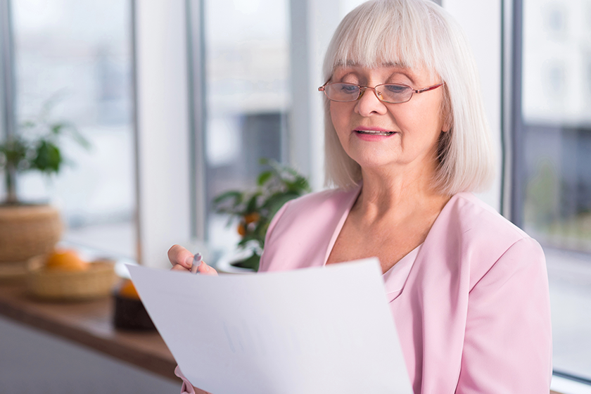 serious businesswoman examining a document