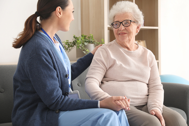 young caregiver senior woman holding hands