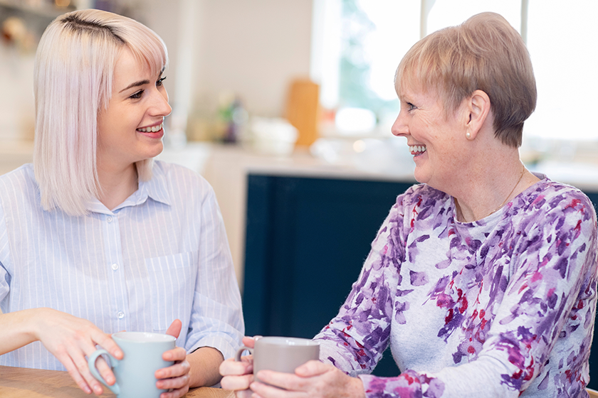 young woman taking time to visit senior young woman taking time to visit senior