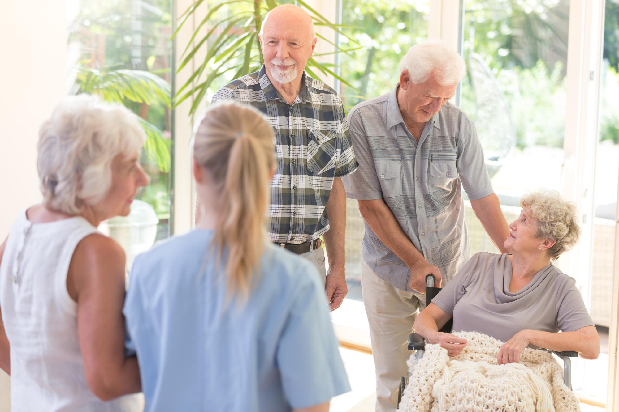 Older,Woman,With,Bright,Blanket,Sitting,In,Wheelchair,And,Talking