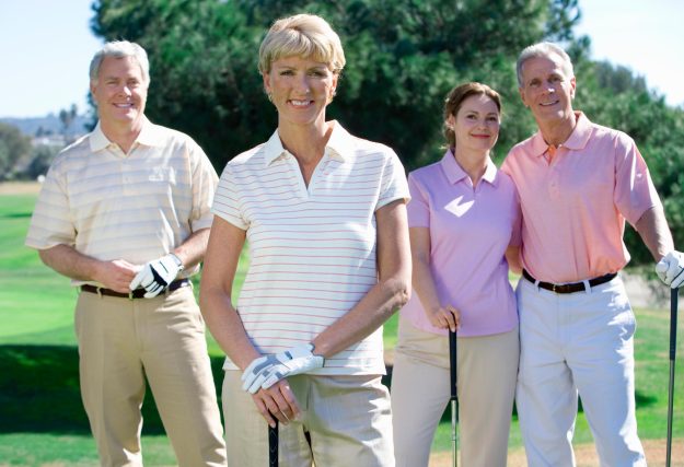 Portrait,Of,Smiling,Mature,Couple,With,Friends,On,Golf,Course