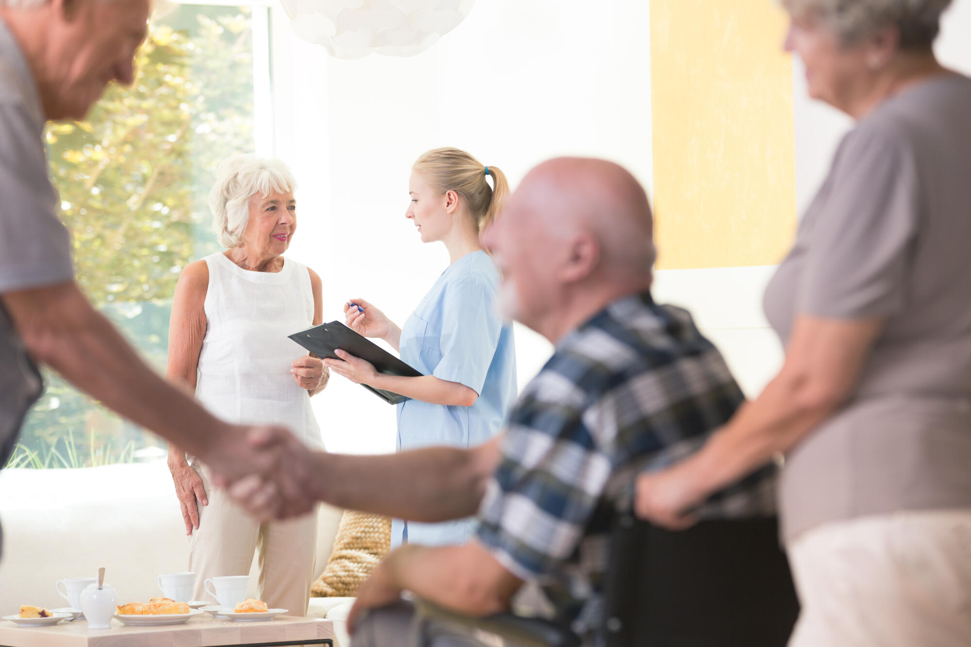 Senior,Woman,Talking,With,A,Nurse,During,Meeting,In,Living Senior,Woman,Talking,With,A,Nurse,During,Meeting,In,Living