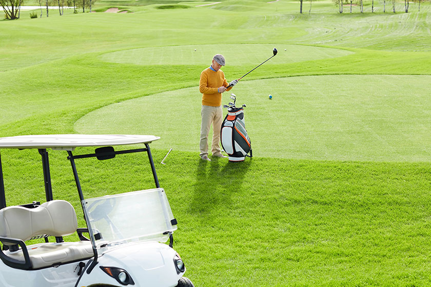 Casual man standing middle large green field while choosing suitable