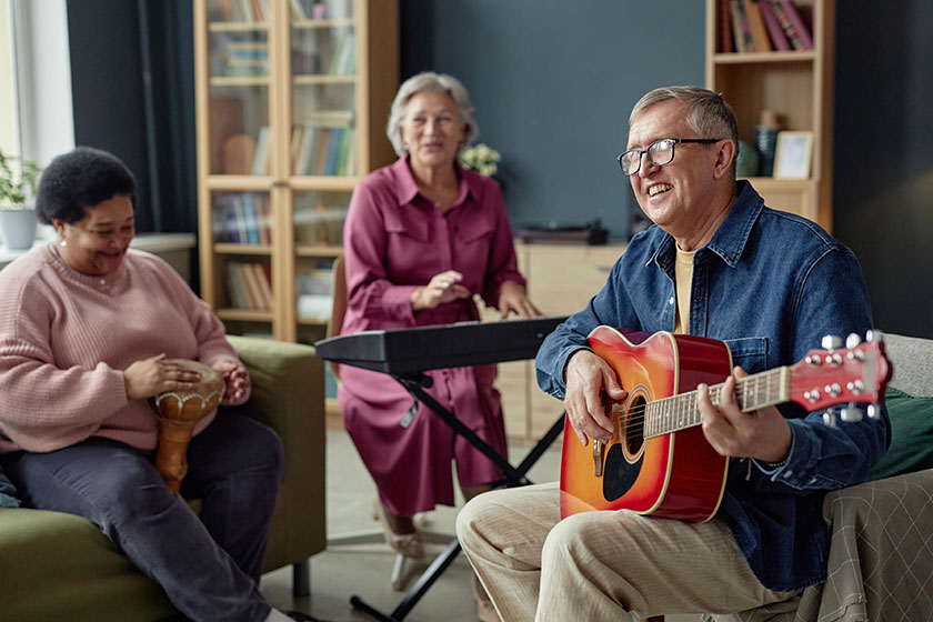 Group joyful senior people playing music together enjoying talent show