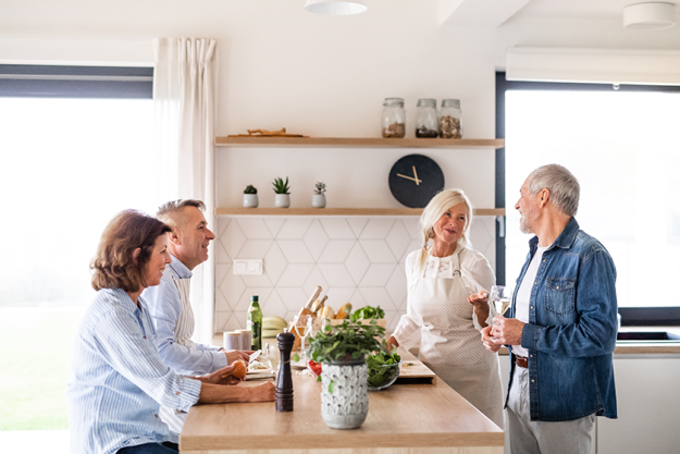 group of senior friends at dinner party at home group of senior friends at dinner party at home
