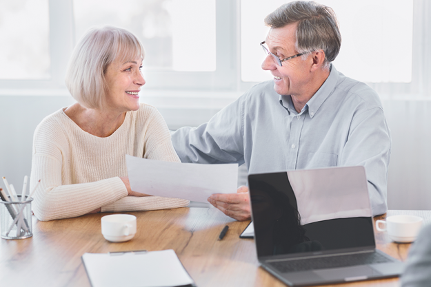 mature couple talking to financial advisor at office