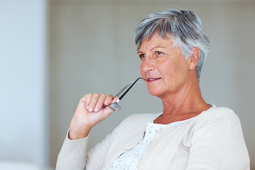 mature woman contemplating thoughtful mature woman thinking while holding glasses mature woman contemplating thoughtful mature woman thinking while holding glasses