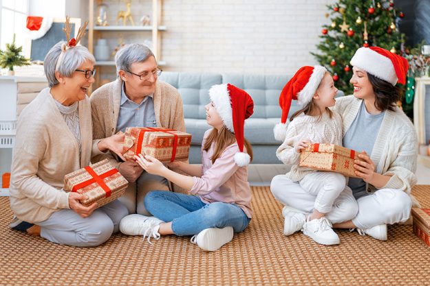 Merry christmas happy holidays grandma grandpa mum children exchanging gifts