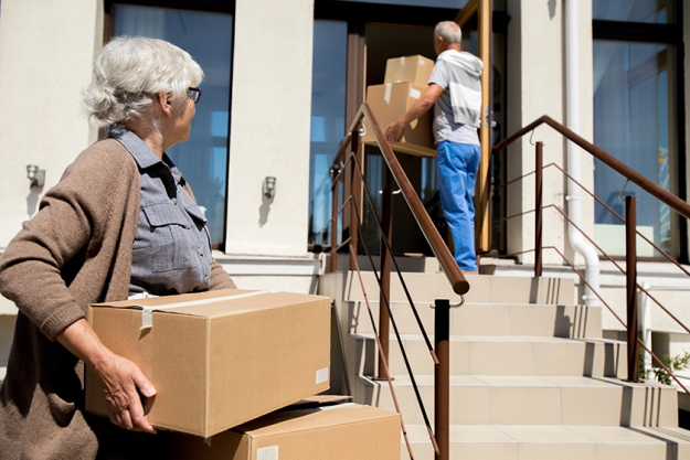 portrait modern senior couple unloading cardboard boxes portrait modern senior couple unloading cardboard boxes