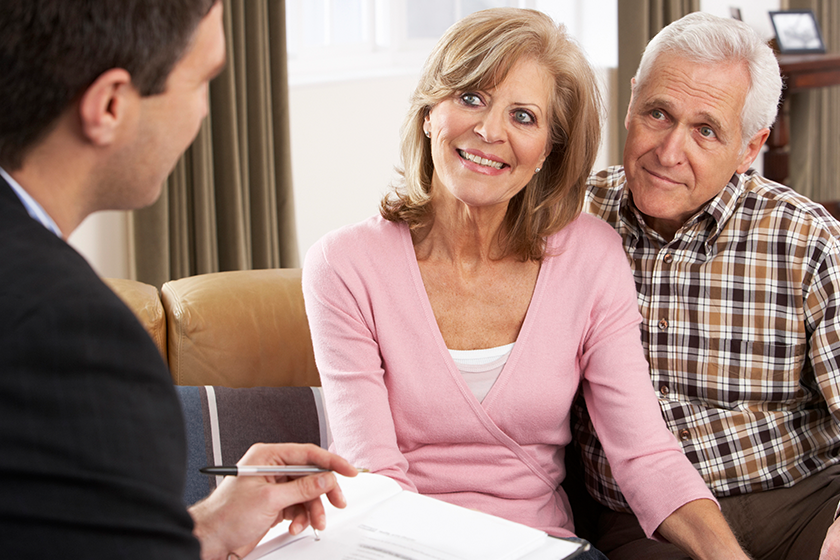 senior couple talking with financial advisor