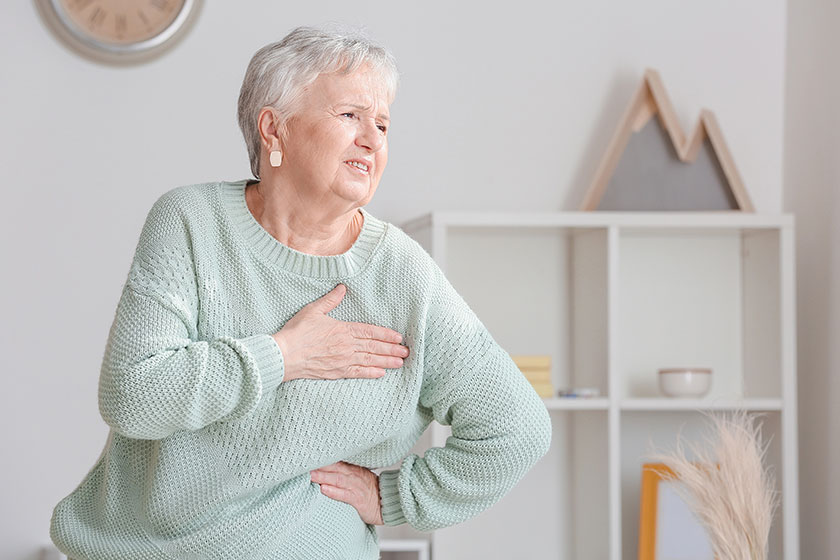 Senior woman suffering from heart attack at home Senior woman suffering from heart attack at home