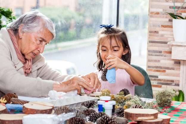 Little girl having fun while making christmas Nativity crafts wi