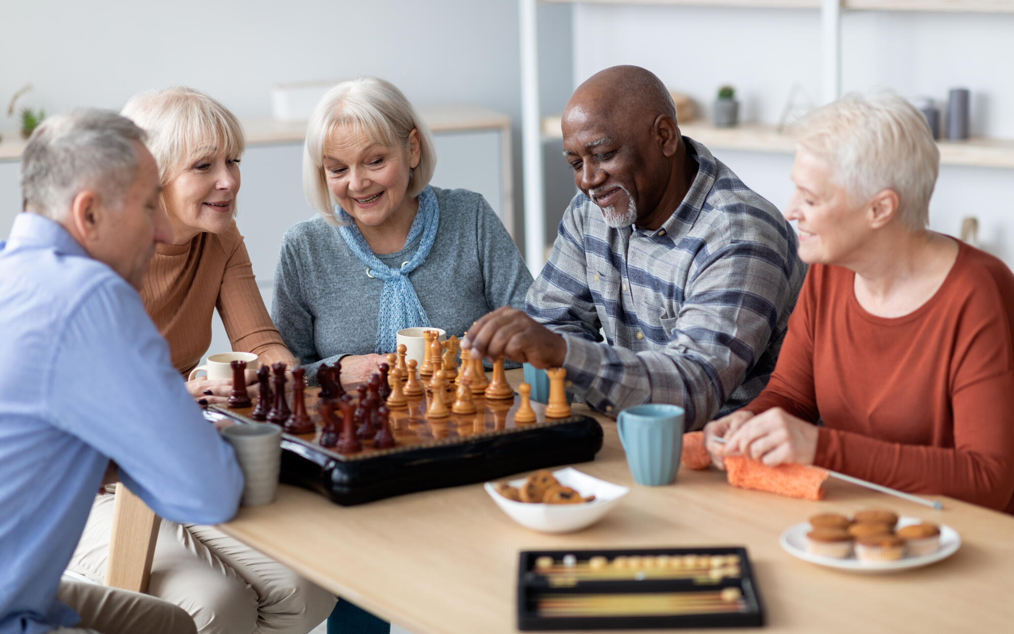Multiracial senior people playing chess at nursing home Multiracial senior people playing chess at nursing home