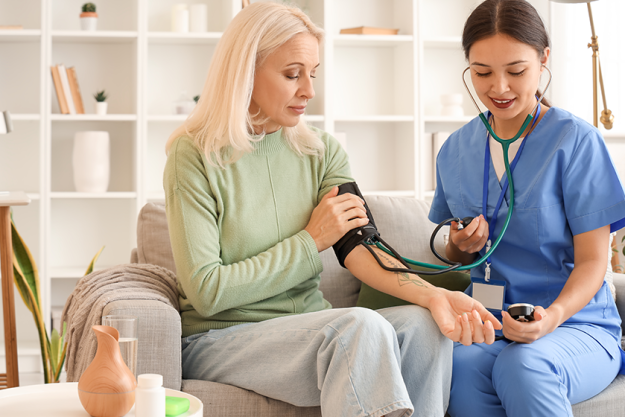 female doctor measuring blood pressure
