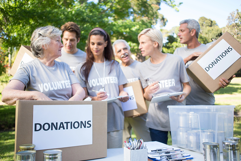 happy volunteer family holding donation boxes