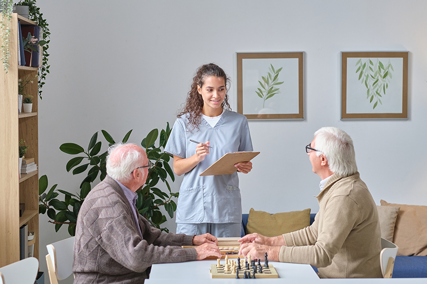 nurse talking to senior men in nursing home