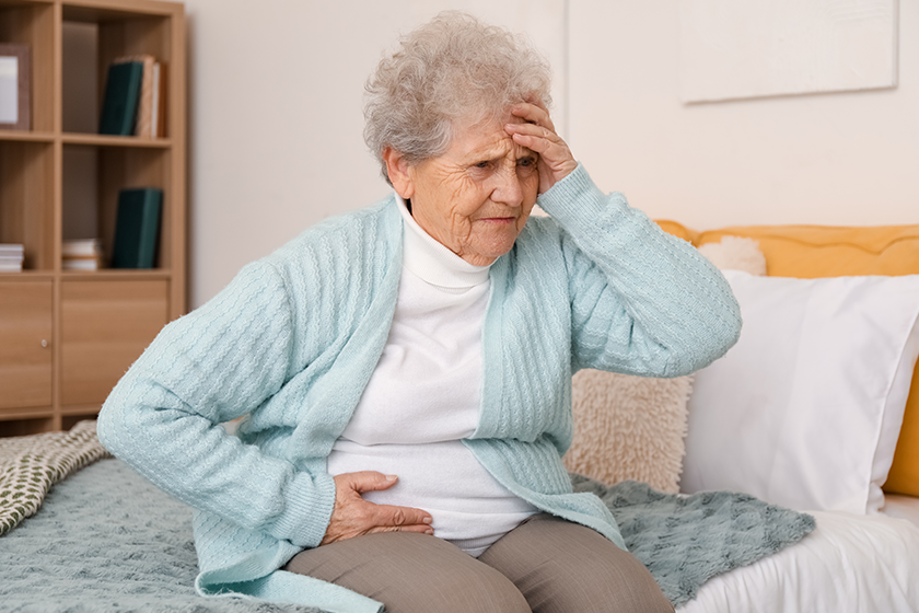 senior woman appendicitis sitting bedroom
