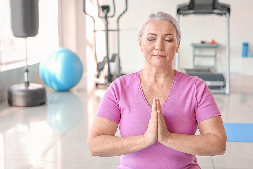 sporty mature woman practicing yoga