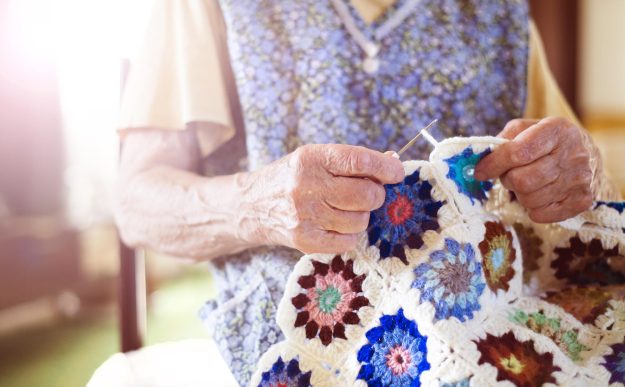 Old,Woman,Is,Knitting,A,Blanket,Inside,In,Her,Living Old,Woman,Is,Knitting,A,Blanket,Inside,In,Her,Living