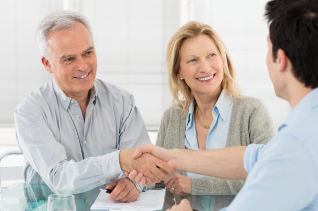 Senior,Happy,Couple,Shaking,Hand,With,Financial,Advisor