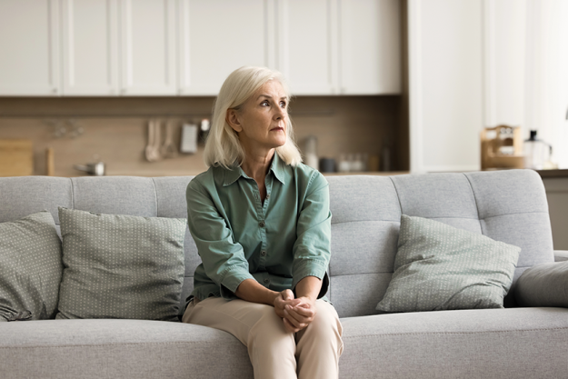 concerned blonde senior woman sitting