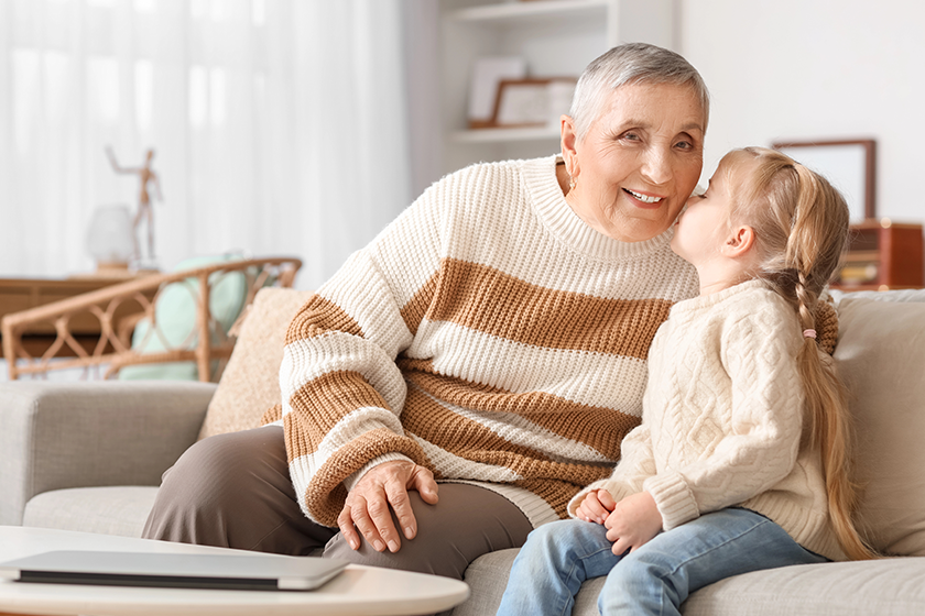cute little girl kissing her granny