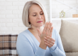 middle aged woman suffering from pain in hands