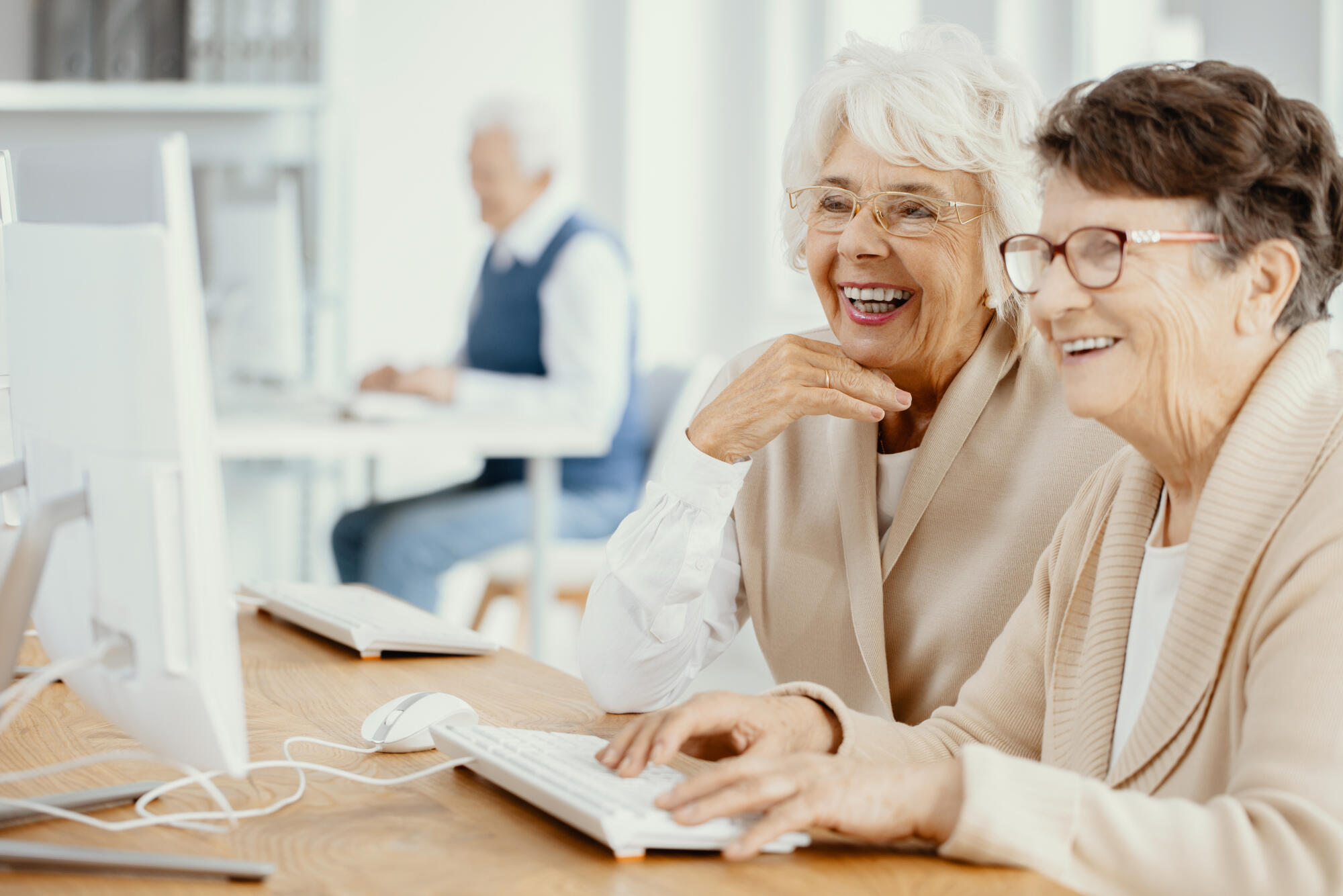 Two,Smiling,Senior,Women,With,Glasses,During,Computer,Classes,For Two,Smiling,Senior,Women,With,Glasses,During,Computer,Classes,For