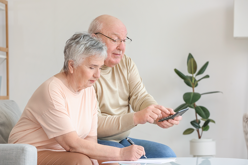 senior couple calculating expenses