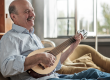 senior hispanic man playing guitar