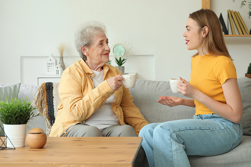 young woman her grandmother drinking tea young woman her grandmother drinking tea