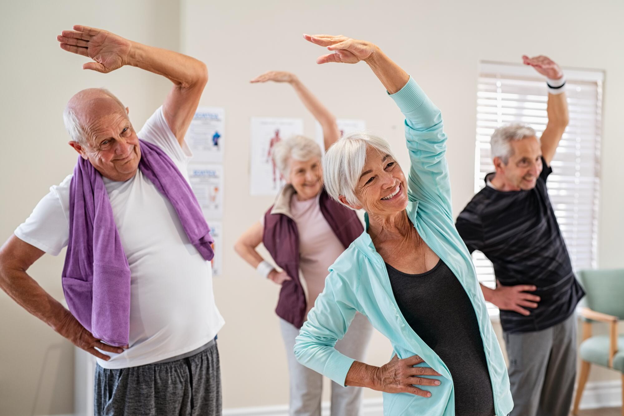 Group,Of,Seniors,Doing,Stretching,Exercise,Together,At,Retirement,Centre. Group,Of,Seniors,Doing,Stretching,Exercise,Together,At,Retirement,Centre.