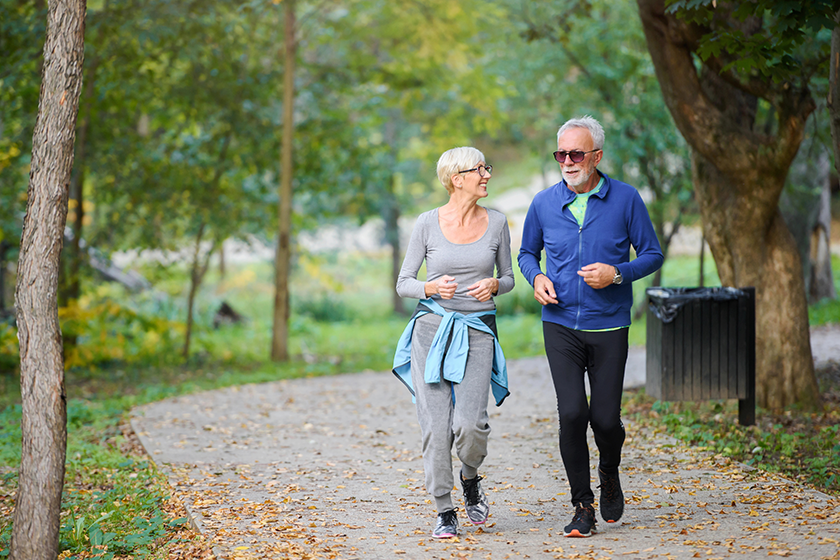 cheerful active senior couple jogging
